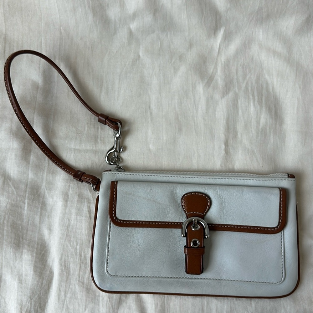 Authentic Y2K Coach wristlet. White leather with brown leather buckle detail.